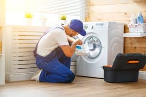plumber repairs a washing machine